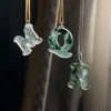 Carved moss agate initial pendants showing letter examples M, Q and R