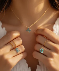 Moss agate initial necklace styled with rings in a wearing photograph