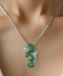 Moss agate seahorse necklace worn with an ivory top