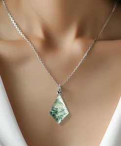 Diamond-shaped moss agate necklace worn with an ivory top