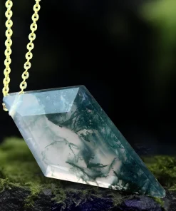 Angled view of faceted kite moss agate pendant showing branching green inclusions