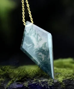 Side view of faceted kite moss agate pendant showing its thickness