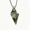 Faceted kite moss agate pendant with silver-colored box chain on an ivory background