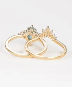 Rear view of pear moss agate engagement ring and curved wedding band