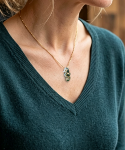 Woman wearing a hand-carved moss agate seahorse necklace