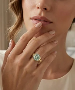 Woman wearing a gold hexagon moss agate vine ring