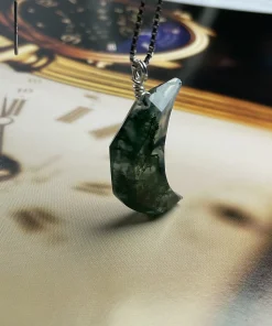 Rear angled view of crescent moon moss agate pendant