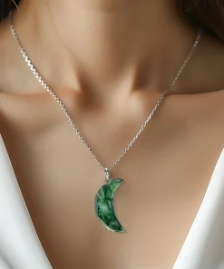 Crescent moon moss agate necklace worn with an ivory top