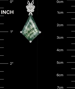 Flower kite moss agate pendant beside inch and centimeter scale markings