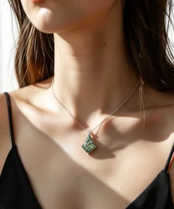 Flower kite moss agate necklace worn with a black top