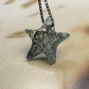 Five-pointed moss agate star pendant suspended from a box chain