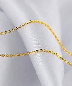 Gold-colored chain links shown on white fabric