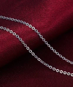 Silver-colored chain links on burgundy fabric