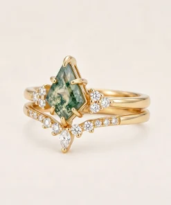 Angled view of moss agate engagement ring and matching curved wedding band
