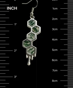 Honeycomb moss agate dangle earring beside inch and centimeter scale markings