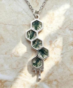 Angled view of five-stone honeycomb moss agate pendant