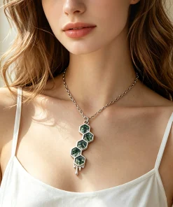 Honeycomb moss agate necklace worn with an ivory top