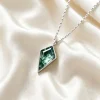 Kite moss agate bezel pendant on ivory fabric with a silver-colored chain