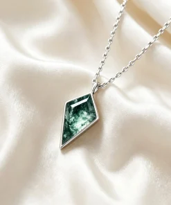 Kite moss agate bezel pendant on ivory fabric with a silver-colored chain