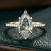 Front view of marquise moss agate ring with small clear shoulder accents
