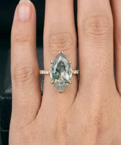 Marquise moss agate ring worn on a hand