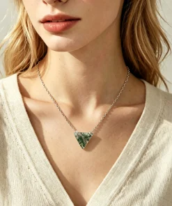 Triangle moss agate necklace worn with an ivory top