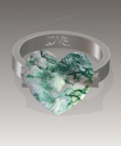 Design rendering of a heart moss agate ring with a silver-colored band and interior engraving