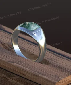 Design rendering of moss agate signet ring with broad polished shoulders and an engraved initial