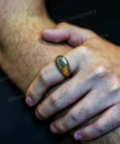 Moss agate signet ring shown worn on a hand