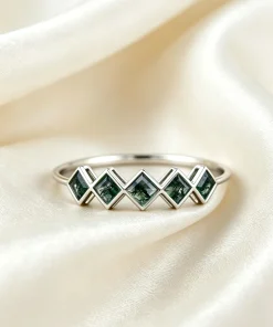 Front view of five-stone square moss agate ring with geometric settings