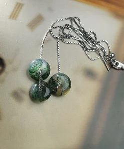 Rear view of round moss agate disc necklace and chain