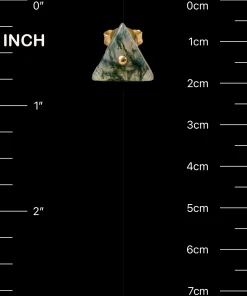 Triangle moss agate stud beside inch and centimeter scale markings
