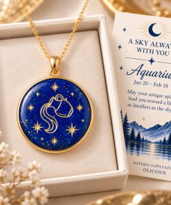 Aquarius zodiac necklace featuring a polished natural lapis lazuli pendant with gold Aquarius constellation design, displayed in an ivory jewelry box with a matching zodiac gift card