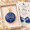 Aries zodiac necklace featuring a polished natural lapis lazuli pendant with gold Aries constellation design, displayed in an ivory jewelry box with a matching zodiac gift card