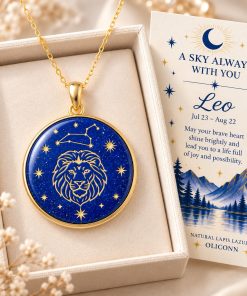 Leo zodiac necklace featuring a polished natural lapis lazuli pendant with gold Leo constellation design, displayed in an ivory jewelry box with a matching zodiac gift card