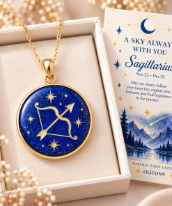 Sagittarius zodiac necklace featuring a polished natural lapis lazuli pendant with gold Sagittarius constellation design, displayed in an ivory jewelry box with a matching zodiac gift card