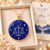 Libra zodiac necklace featuring a polished natural lapis lazuli pendant with gold Libra constellation design, displayed in an ivory jewelry box with a matching zodiac gift card