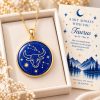 Taurus zodiac necklace featuring a polished natural lapis lazuli pendant with gold Taurus constellation design, displayed in an ivory jewelry box with a matching zodiac gift card