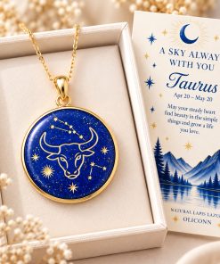 Taurus zodiac necklace featuring a polished natural lapis lazuli pendant with gold Taurus constellation design, displayed in an ivory jewelry box with a matching zodiac gift card