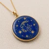 Angled front view of Capricorn lapis lazuli pendant with gold-colored Sea-Goat and star motifs