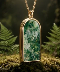 Angled view of Forest Gate moss agate pendant showing its polished frame