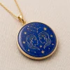 Angled front view of Gemini lapis lazuli pendant with gold-colored Twins and star motifs