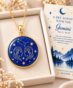 Gemini lapis lazuli necklace displayed in an ivory box beside a zodiac card