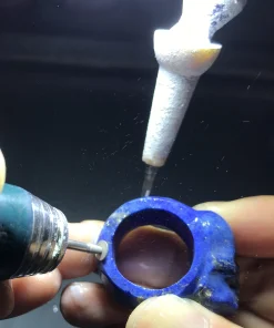 Carving the continuous lapis lazuli ring band with a rotary tool