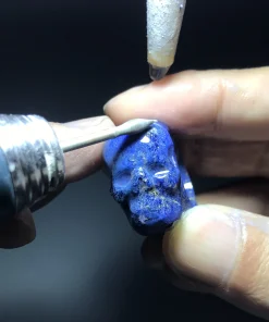Lapis lazuli skull ring being shaped with a rotary carving tool
