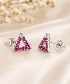 Angled view of ruby triangle studs showing posts and butterfly backs