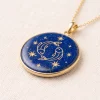 Front angled view of Pisces lapis lazuli pendant with gold-colored paired fish and stars