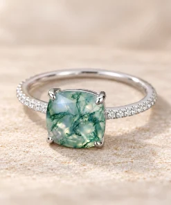Front view of cushion-cut moss agate ring with green branching patterns and four prongs