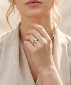 Close wearing view of cushion-cut moss agate ring on a model hand