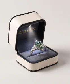 Kite moss agate ring illustrated in an open cream OLICONN jewelry box